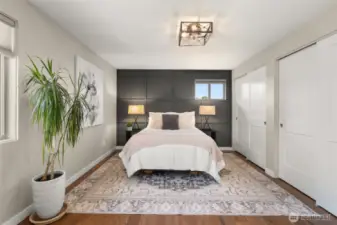 Feature wall in the primary bedroom in only another example of the classic decorator touches. Warming up the room and setting it apart. Both closets have custom shelving to maximize use.