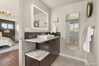 Back lit mirror quartz counters and designer tiles continue in the classic fashion of this house.