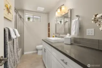 No skimping on the downstairs bathroom. Love the designer tiles and colors.