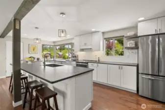 Quartz counters with leather finish are the perfect contrast to the light and bright kitchen.