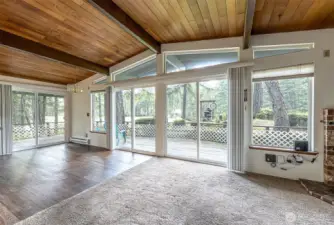 great view to the golf course.  Dining room is the laminate flooring area. Check out the windows, exposed beams and wood plank ceiling!