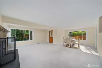 Large dining room with fireplace and extra bonus room. And a door leading outside.