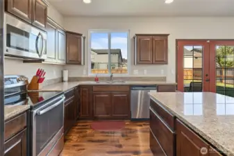 Plenty of counter space and cabinetry, plus a window peeking out to the back yard makes for enjoyable time in the kitchen