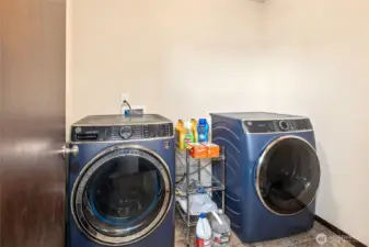 With a sleek GE front-load set from 2021, this laundry room keeps the chores easy and efficient.
