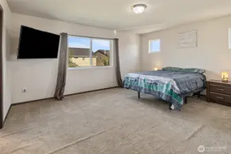 Stretch out in a primary bedroom built for big furniture and even bigger comfort. An en-suite bath with double sinks, soaking tub, private toilet room, and a generous walk-in closet complete the retreat.