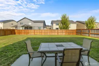 A large, flat, partially fenced yard with a concrete patio right off the kitchen— ready for games, gardens, or gatherings. Bonus: irrigation system keeps things green (just $45.50/month, April–October)