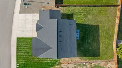 A large, flat, partially fenced yard with a concrete patio right off the kitchen— ready for games, gardens, or gatherings. Bonus: irrigation system keeps things green (just $45.50/month, April–October)