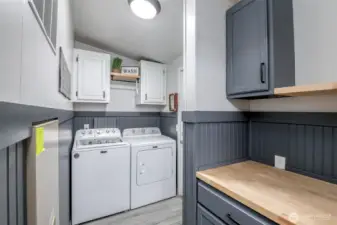 Utility room features storage, furnace and folding counter, plus leads to garage
