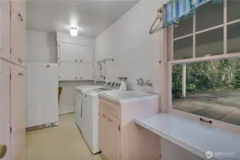 Oversized main floor laundry room/pantry with built-in sink.
