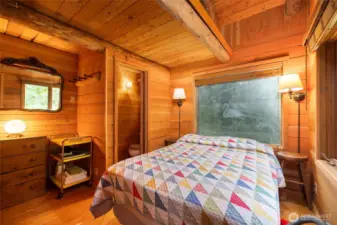 Bed in bunkhouse and adjacent half bath