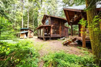 Main cabin, shop and golf cart carport and bunkhouse to the right