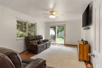 Family room with slider leading to sideyard and the hot tub