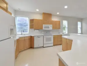 The kitchen boasts lots of cabinets and matching appliances.  Look at the size of the island!