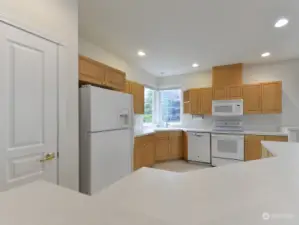 Lots of windows and recessed lighting make the kitchen bright and welcoming. There's a nice view of the backyard from the windows over the sink.