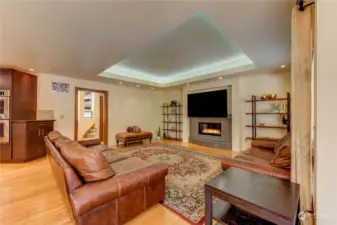Family room with gas fireplace and custom lighting