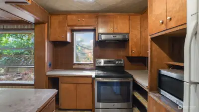 The kitchen offers newer appliances but is ready for some new life and possibly more space in here.