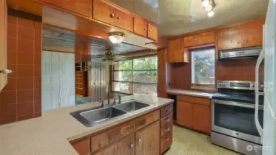 Kitchen is smaller with possible potential to open up to living room for more space and open concept layout.