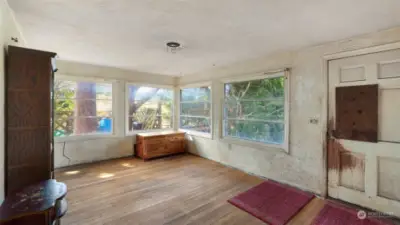 Wall of windows in this living space brings tons of natural light, allowing you to truly see all the potential this home has to offer.