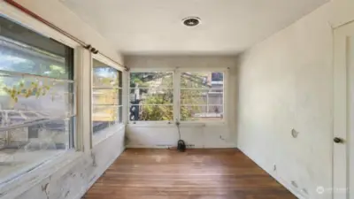 Second bedroom surrounded by windows is great as is or even bump out the home a bit to create a large primary suite and add a second bathroom here.