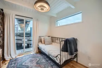 Te second bedroom can serve as an office space or guest bedroom. Love the retro light fixture.