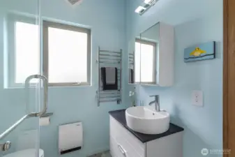 Bright, fresh second bath with a clean coastal color palette and modern design.