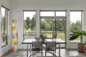 Dining area flows to the deck, blurring the line between indoors and nature.