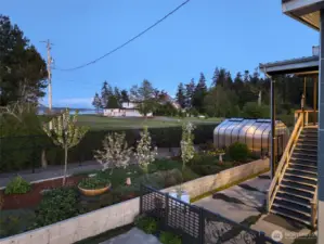 Blooming orchard trees and raised beds offer a lush and functional retreat.