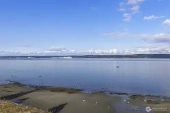 Peaceful shoreline with calm waters and panoramic views.