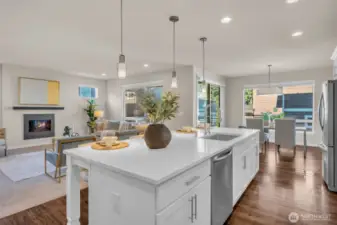 Massive 10ft quartz island separating the kitchen from the living space.