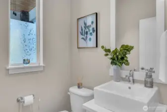 Downstairs powder room off entryway.