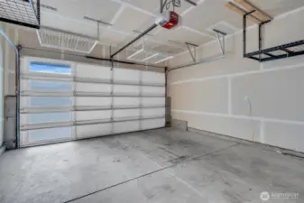 Oversized double car garage with ceiling storage.