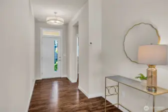 Entrance to the home with powder room and coat closet off to the side.
