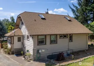 Side of home has covered porch/mud room entry into the kitchen area. Also note the exterior stairway/entry into the basement