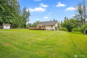 ChatGPT said:  Expansive backyard with lush lawn, mature trees, and a large entertainment deck—perfect for gatherings, gardening, or simply enjoying the tranquility of this private retreat.