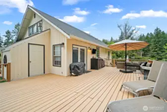 Expansive entertainment deck featuring ample space for lounging, grilling, and dining
