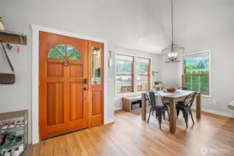 ChatGPT said:  Charming entryway opens to a sunlit dining area with large windows, warm hardwood floors, and a modern farmhouse light fixture—perfect for everyday meals or entertaining.