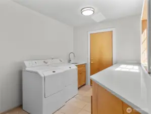 Main floor laundry room features storage