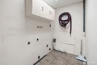 Utility room on lower level with built-in vacuum system