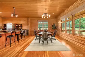 Dining room with large windows showing off the backyard.