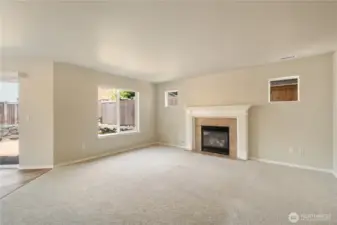 Family room with fireplace and view of the back yard.