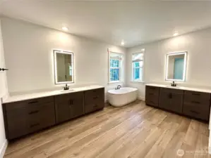 Primary bath with a ton of counter space that is separated.