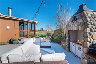 Outdoor space with oversized outdoor stone fireplace.