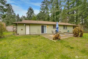 Large fenced backyard with patio and shed