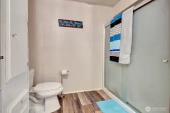 Large, no step seated shower for your convenience. Easy care laminate floors.