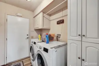 Utility room has storgate cabinets for your laundry and all your cleaning accessoires. Access door into the garage for your convenience.