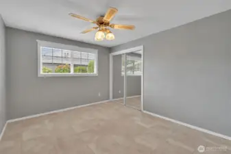 Primary bedroom with ceiling fan.