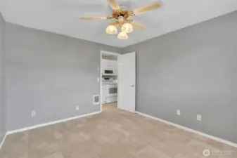 Primary bedroom with ceiling fan.