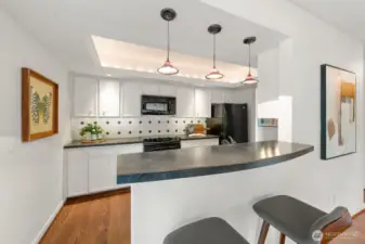 Kitchen with eating bar open to family room