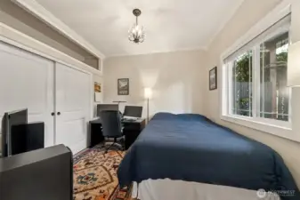 Main floor bedroom over looks the front covered porch with large walk-in closet. Nice touches with the crown molding and maintaining the charm with classic lighting.