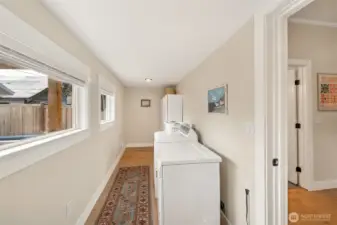 Located just off the kitchen is the laundry room with extra storage options.